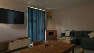 a living room with a couch and a table at Pine villa sadgeri in Sadgeri +10 photos