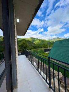 a balcony with a view of the mountains at Pine villa sadgeri in Sadgeri