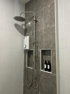 a shower in a bathroom with two bottles of wine at The Hidden Place Bangtao in Bang Tao Beach +29 photos