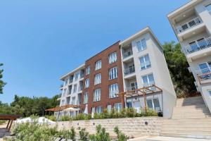 an apartment building with stairs in front of it at Cosy Adriatic Studio in Kotor