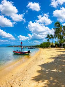a boat sitting on the shore of a beach at Aufwachen im Paradies Private Poolvilla 50 m vom Strand in Nathon Bay