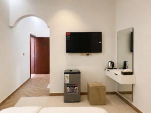 a room with a flat screen tv on a wall at Bin Fhaid Suites in Salalah
