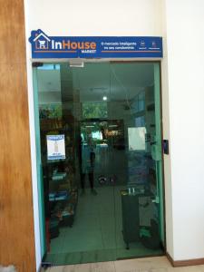 a entrance to a store with a glass door at Iloa Studio Alagoas sofisticação de alto padrão in Barra de São Miguel