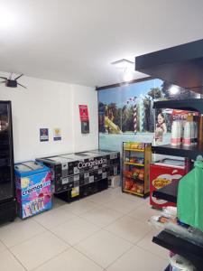 a store with a cocacola advertisement on the wall at Iloa Studio Alagoas sofisticação de alto padrão in Barra de São Miguel