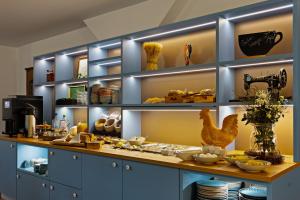 a kitchen with a counter with plates and dishes at Landgasthaus Fischer in Bad Nenndorf