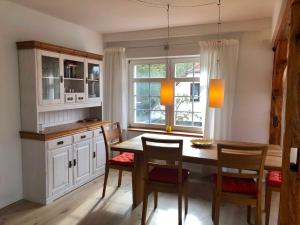 a kitchen with a table and chairs and a window at Kapitänsdeck in Wustrow