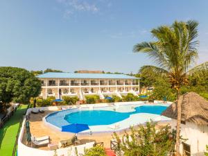 a resort with a large pool and a building at Canary Kendwa Beach Resort in Kendwa