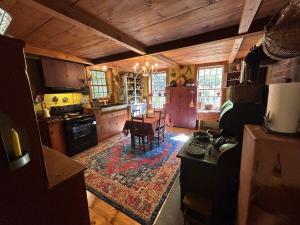 a kitchen with a table and a dining room at Old Deerfield Treasure! in Deerfield