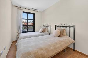 two beds in a bedroom with a window at Luna in San Blas in San Miguel de Abona +22 photos