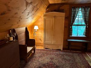 a room with a chair and a window in a cabin at Old Deerfield Treasure! in Deerfield