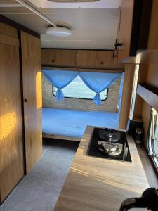 a kitchen with a stove and a bunk bed at Pole namiotowe u Józia in Borne Sulinowo +9 photos