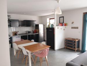 a kitchen and dining room with a table and chairs at La Belle Florentine in Saint-Florent-le-Vieil