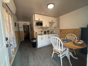 a kitchen with a wooden table and chairs and a table and a kitchen at The conch cottage in Crystal River