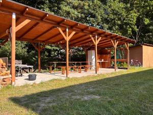 a wooden pavilion with a picnic table in a park at Pole namiotowe u Józia in Borne Sulinowo