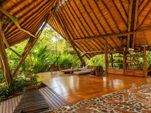 a large room with a wooden floor and a bamboo roof at Hotel Boutique Maitta en Doradal Antioquia in Doradal +119 photos
