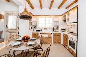 a kitchen with a round table and chairs at Boriadon Rustic Countryside Homes in Naxos Chora