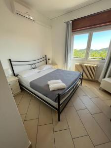 a bedroom with a bed and a large window at Hotel Ristorante San Michele in Ome