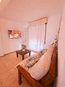 a living room with a couch and a table at OLO Hostel Boutique & Bar Club SANTA FE in Santa Fe