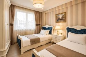 a bedroom with two beds and a window at REAL KiNG RESiDENCE in Trabzon