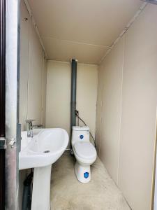 a bathroom with a toilet and a sink at Aspan Kazakh Ger Camp in Ölgiy +6 photos