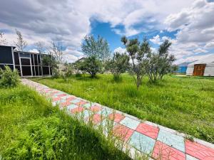 a field of grass with a brick wall at Aspan Kazakh Ger Camp in Ölgiy