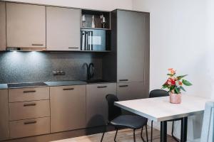 a kitchen with brown cabinets and a table with chairs at Fewo Mauterndorf in Mauterndorf
