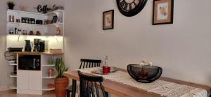 a dining room with a table and a clock on the wall at Maison Centrale - Free Private Parking - Luxury Stay in Serres Center in Serres +22 photos