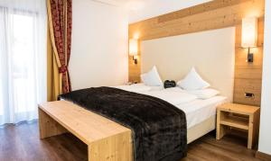 Postel nebo postele na pokoji v ubytování Hotel Dorfer Alpine&Charming