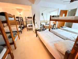 a dorm room with several bunk beds in it at OLO Hostel Boutique & Bar Club SANTA FE in Santa Fe