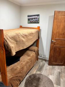 a bedroom with a bed with a blanket on it at Alumine in Coronel Suárez
