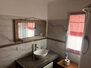 a bathroom with a sink and a mirror at Alumine in Coronel Suárez