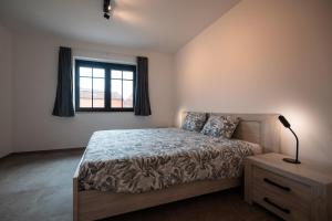 a bedroom with a bed and a window at Horse Valley in Tongeren