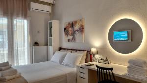 a bedroom with a bed and a desk and a mirror at Maison Centrale - Free Private Parking - Luxury Stay in Serres Center in Serres