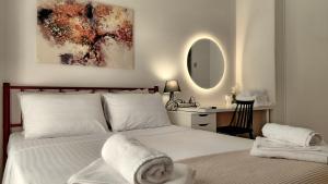 a bedroom with a bed and a desk with a mirror at Maison Centrale - Free Private Parking - Luxury Stay in Serres Center in Serres