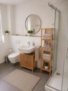 a bathroom with a sink and a toilet and a mirror at Apartments Alma in Pag +50 photos