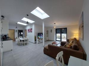 a large living room with a couch and a kitchen at CDP Apartmanok in Alsóörs