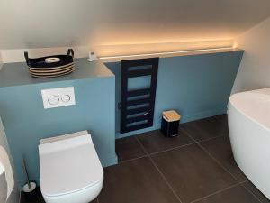 a bathroom with a white toilet and a sink at Lilau - Villa de charme avec parking et jardin près de Chantilly in Gouvieux +16 photos