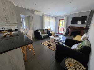 a living room with couches and a living room with a fireplace at The woods at Eleven in White River