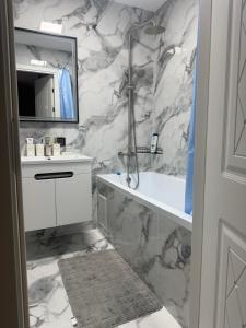 a bathroom with a white sink and a mirror at Kogălniceanu 24 in Căuşeni