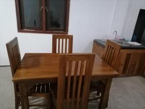 a dining room table with chairs and a desk at Nimna Panadura in Panadura