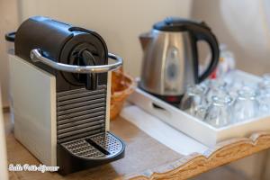 a coffee maker sitting on top of a counter at La Maison Des Buis in Falaise
