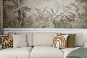 a couch with pillows on it in a living room at Svyvo Cologne - Serviced Apartments Ehrenfeld in Cologne