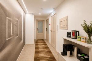 a hallway with white walls and wood floors and a hallway with a door at Rooms4you 1 in historic center of Braga in Braga