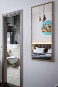a mirror hanging on a wall in a bathroom at Hotel Bregenz in Berlin +166 photos