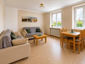 a living room with a couch and a table at Ferienwohnung am Arberzentrum in Zwiesel