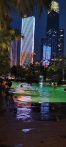 a fountain in a park in a city at night at Agile Residence By Arshad in Kuala Lumpur