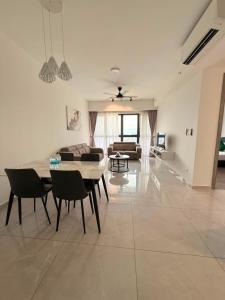 a living room with a table and chairs and a couch at Agile Residence By Arshad in Kuala Lumpur