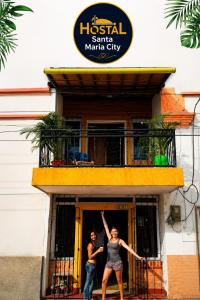 a man and a woman standing outside of a building at Hostal Santa Maria City in Santa Marta +8 photos