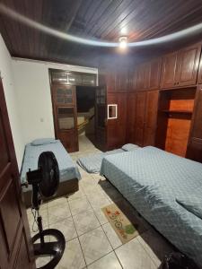 a room with two beds and a camera in it at Quarto Confortável no Centro - Bela Ilha House in São Luís