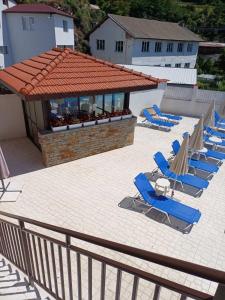 a group of blue lounge chairs on a patio at Hotel Deyanira in Gorno Dryanovo